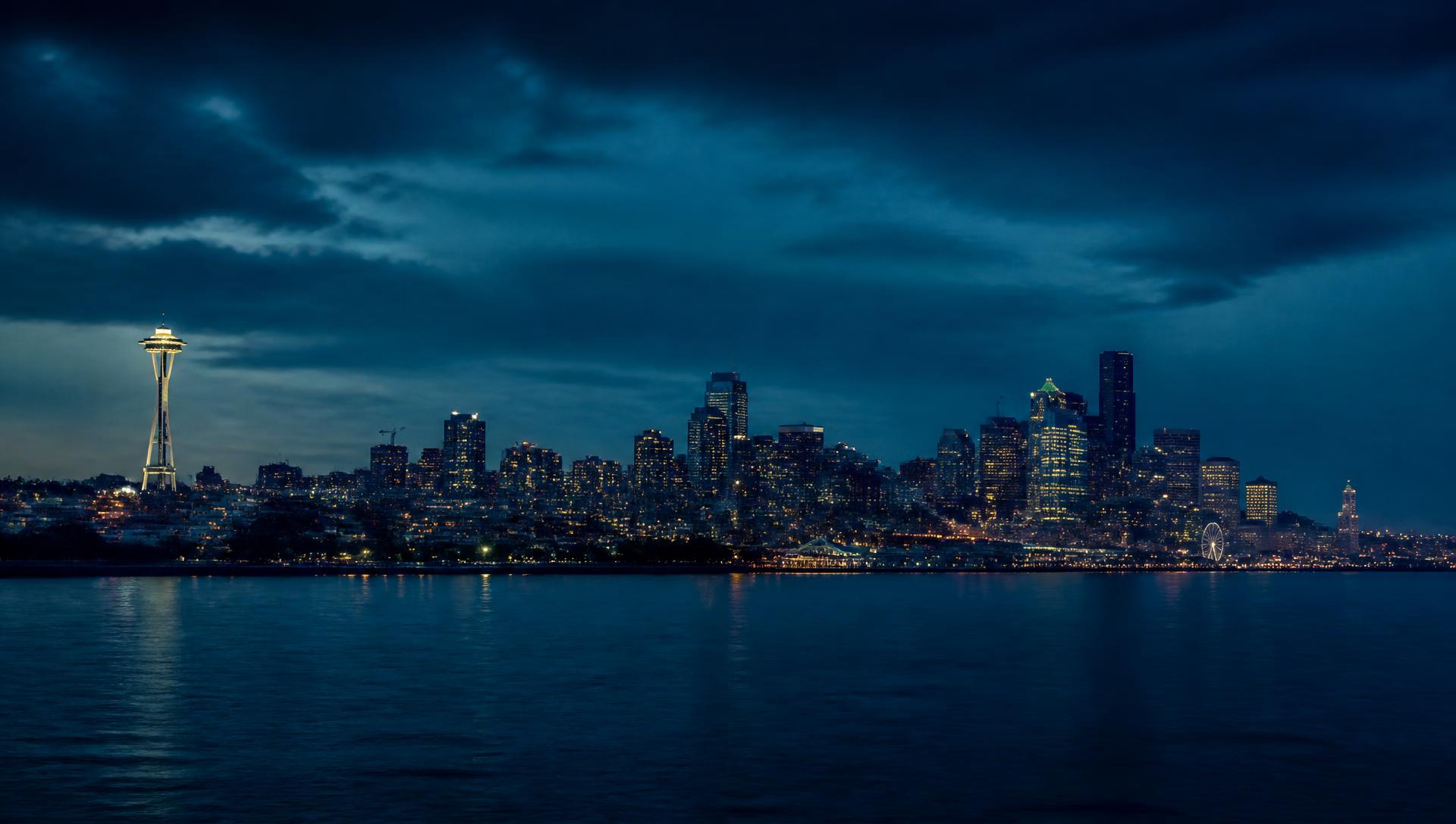 The Seattle skyline at dusk with the Space Needle across Elliott Bay